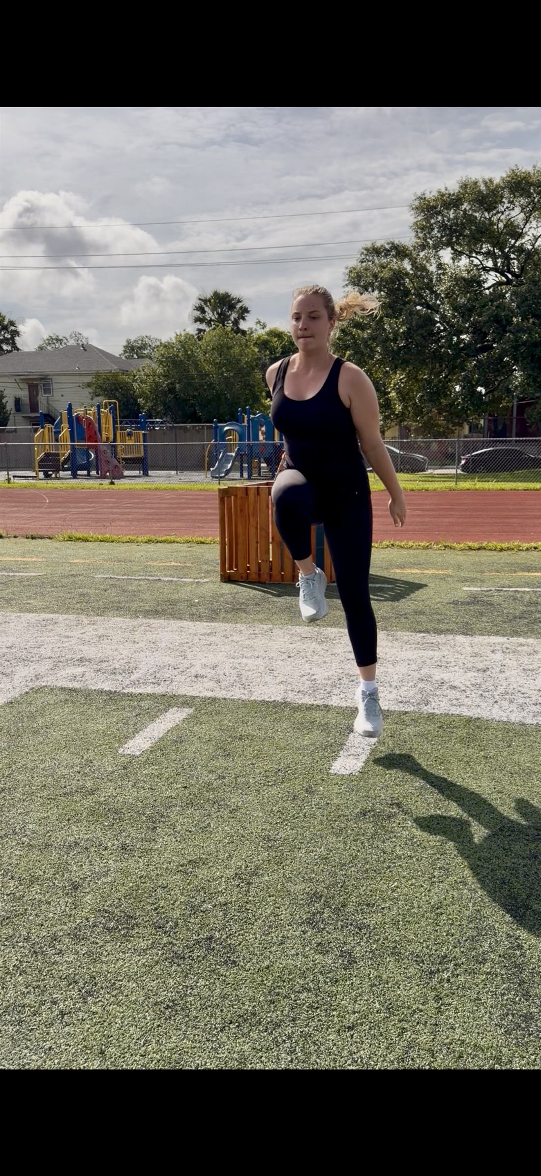 An athlete mid-air in an explosive jump drill — power expressed on earned stability