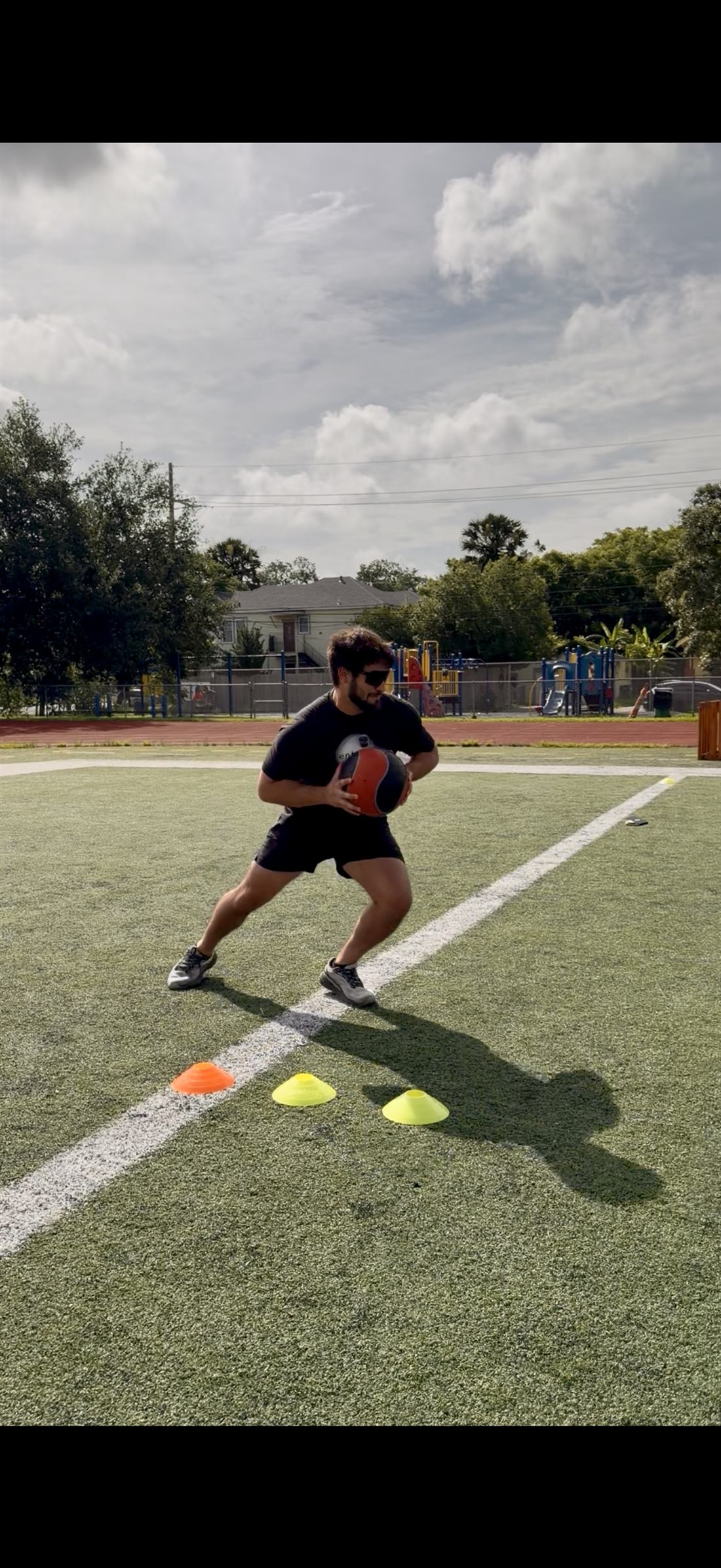 Ellis Wells loading a rotational medicine ball throw on the field